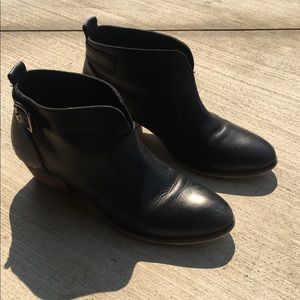 Black ankle boots with side gold buckle.